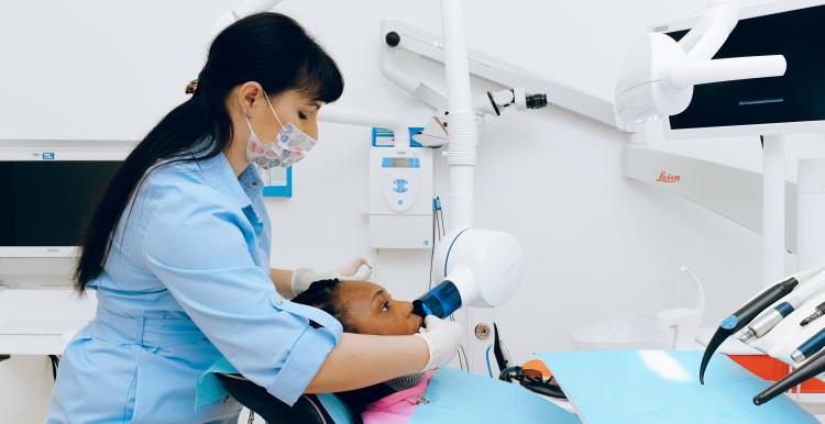 A young black woman undergoes a dental treatment