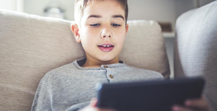 Boy playing on iPad
