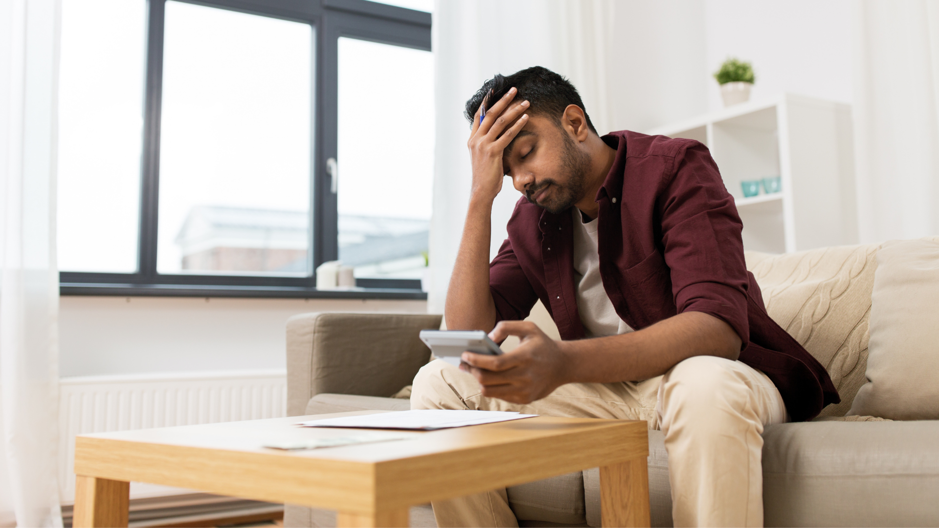 Man waiting for a call on his sofa