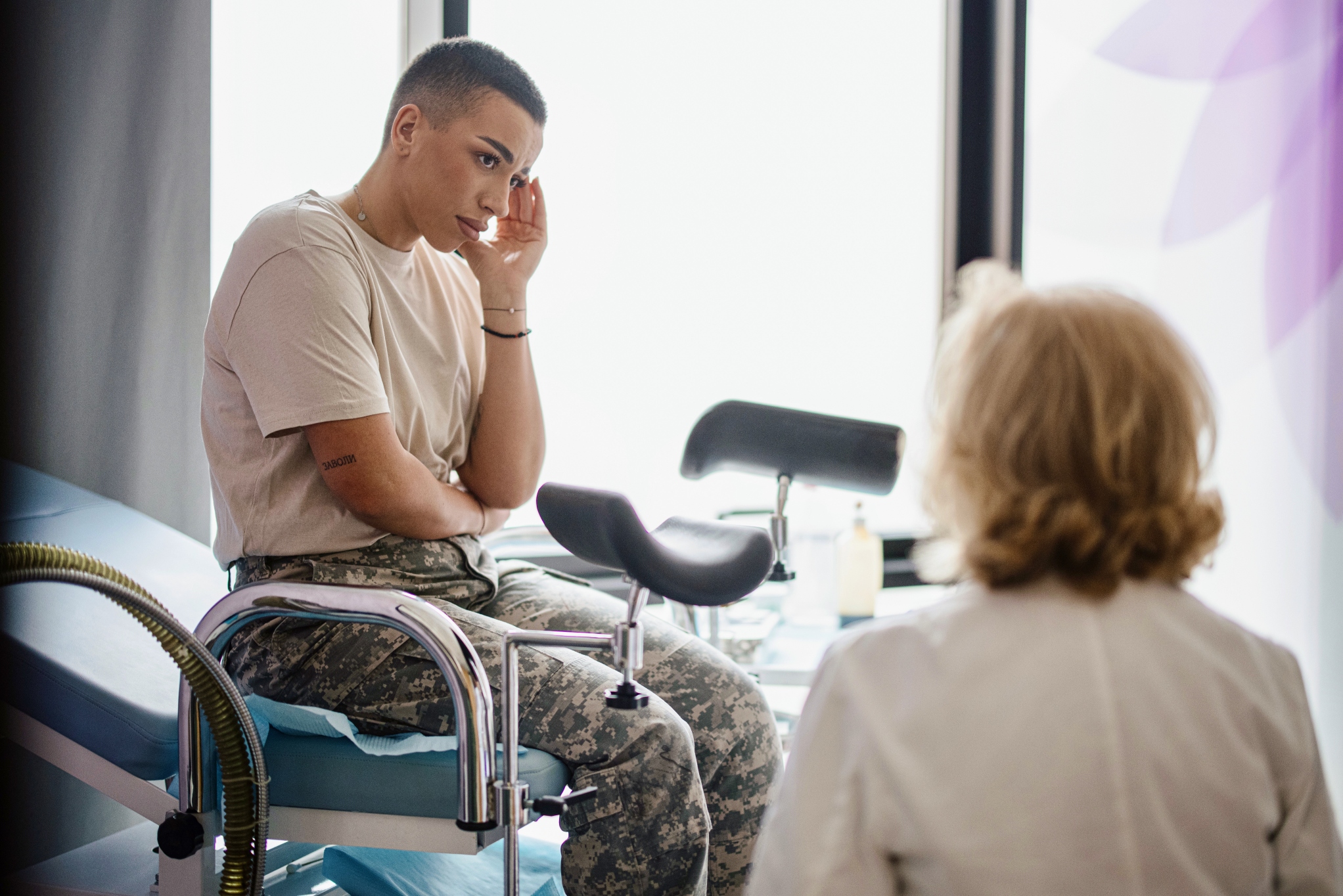 Woman in exam room with female doctor