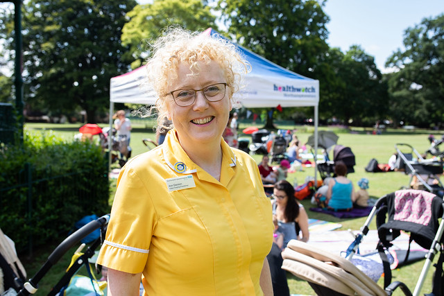 A blonde woman wearing a yellow medical uniform