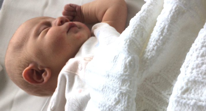 Emily as a baby, sleeping in her cot