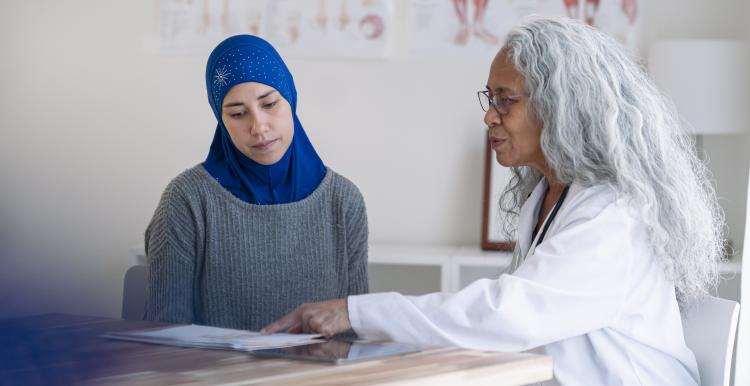 Muslim woman wearing a hijab attending a wellness check with her primary care doctor