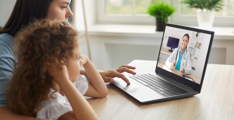 Healthy mother and child having online telemedicine consultation with remote doctor