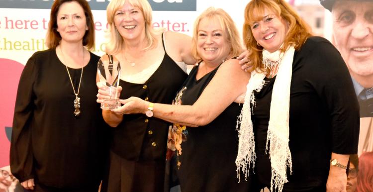 Four women holding a Healthwatch Network award