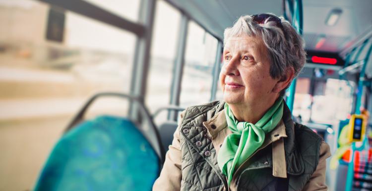 lady sitting on a bus looking out of the window