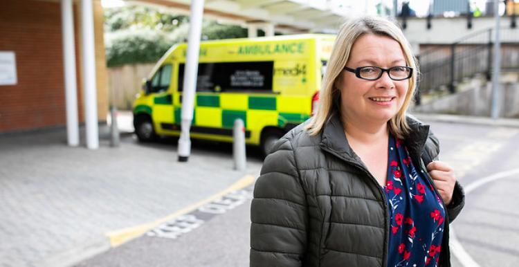 Woman in front of an ambulance 