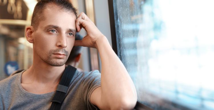 Man on a train looking out of the window