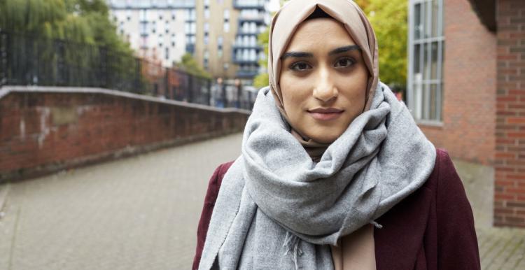 Woman wearing a headscarf standing outside