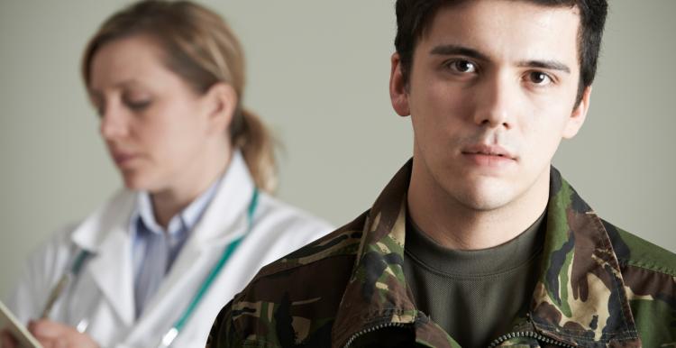 A young soldier with a doctor in the background