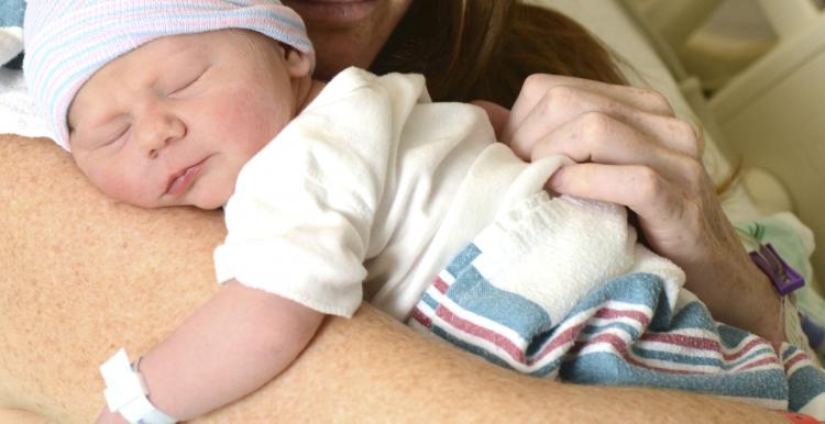 A mother holding her newborn in hospital