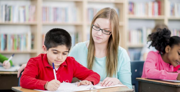 Teacher helping a child with learning