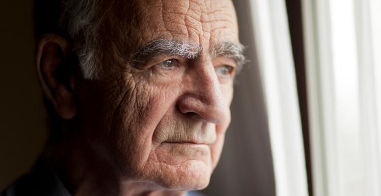 Older man looking out of the window