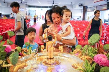 Buddhist devotees visit Wisma Buddhist at Old Klang Road to celebrate Wesak Day. Volunteers and visitors' schedules are packed with vegetarian meals preparation, flower offerings, candle lighting, Little Buddha bathing and prayers chanting.