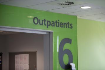 A hospital sign says outpatient care