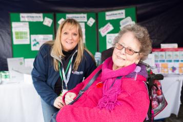 Elderly woman in a wheelchair next to a Healthwatch volunteer