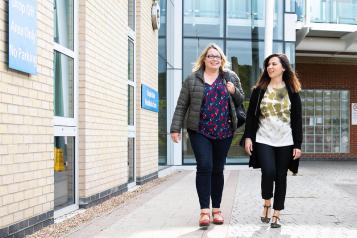 Women walking outside a hospital Women walking outside a hospital