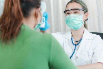 A female dental surgeon talking to a patient