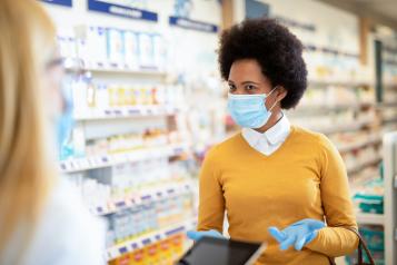 Woman wearing a mask in a pharmacy