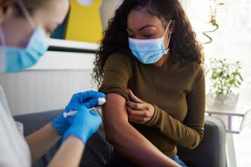 Young woman receiving her vaccination
