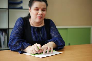 Blind woman using Braille