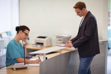 Man talking to receptionist
