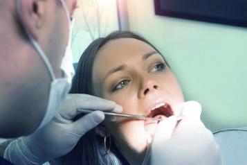 Woman getting her teeth checked by a dentist