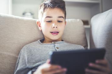 Boy playing on iPad