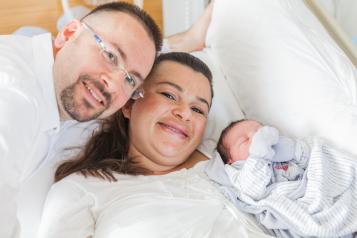 mum and dad with baby in hospital  