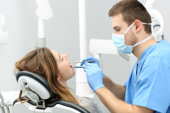 Dentist looking at patient's mouth
